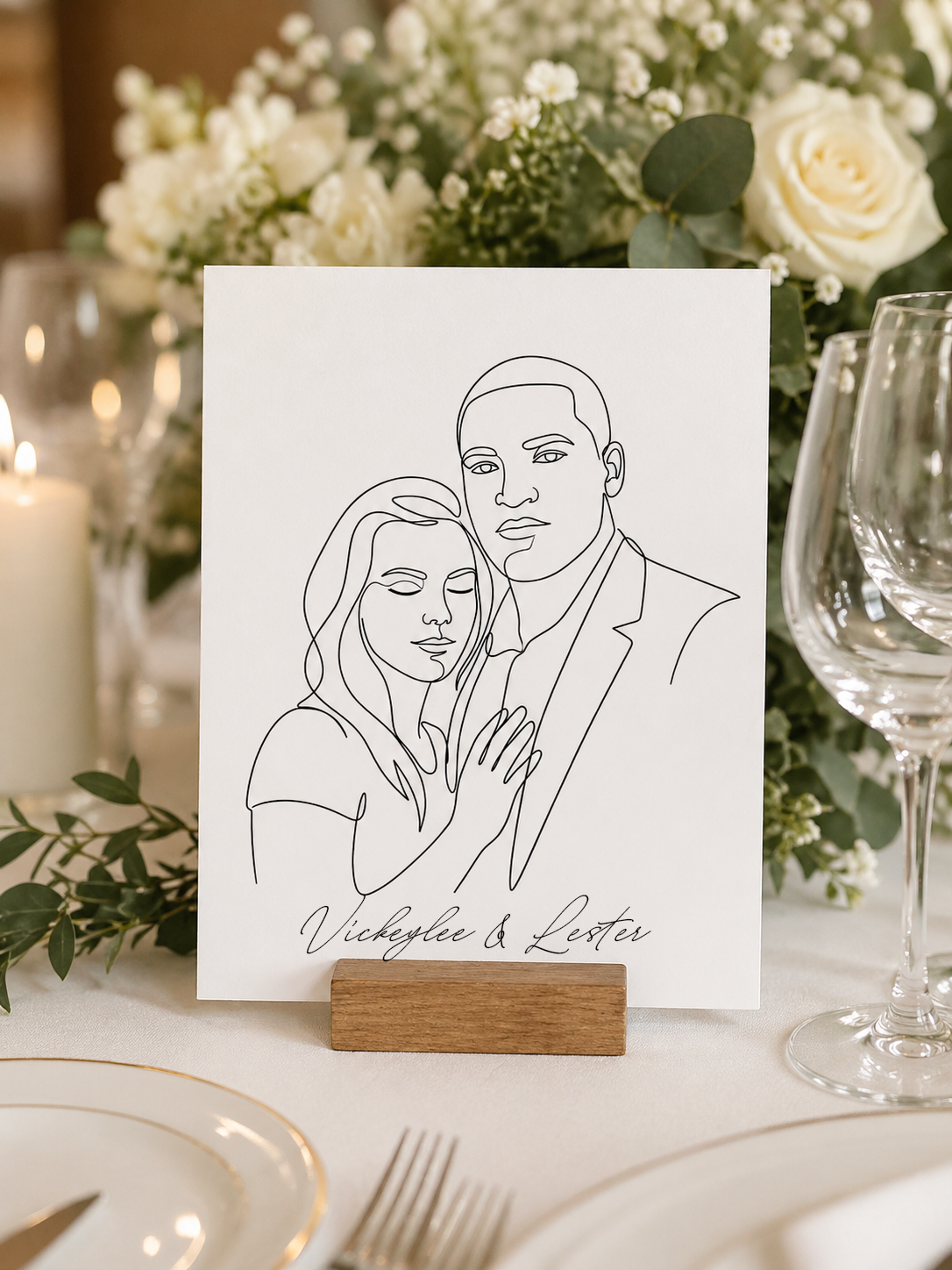 Line art portrait of Vickeylee & Lester on a wooden stand at a wedding table